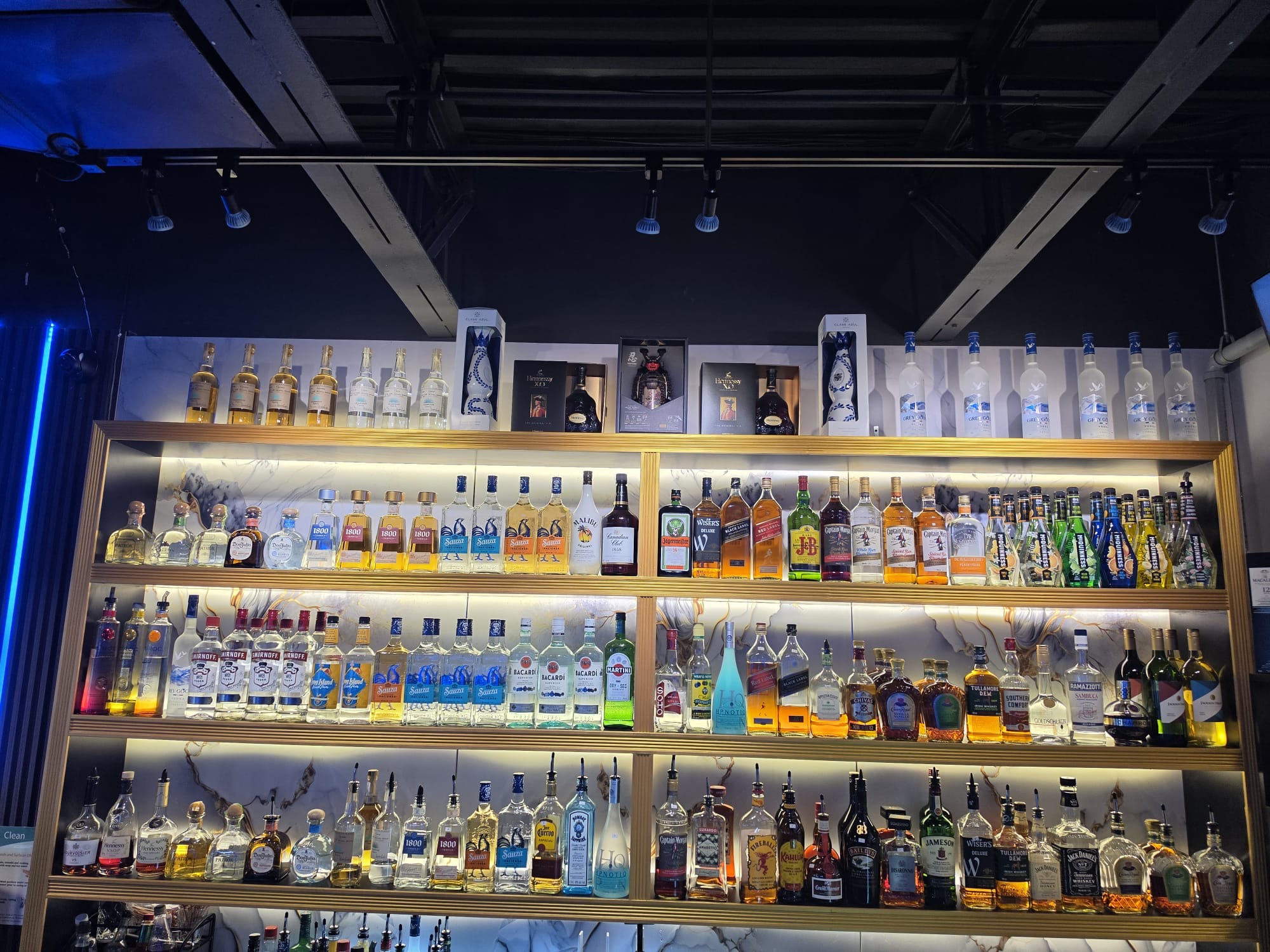 Backlit liquor shelf behind the bar at King Billiards in Westdale, Hamilton